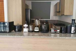 a kitchen counter with a blender and other appliances at Alojamiento entero en la Aurora. in Daule