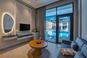 a living room with a blue couch and a table at KAY Homes in Ras al Khaimah