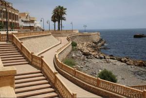 a set of stairs next to the ocean with a building at Vista la Mar in Villaricos