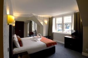 a hotel room with a bed and a television at Columba Hotel in Oban