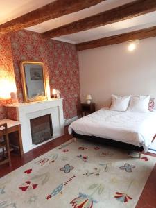 a bedroom with a bed and a fireplace at Le Mas Palegry Chambres d'hôtes Perpignan in Perpignan