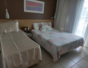 a bedroom with two beds and a window at Aldeia das Aguas Village in Barra do Piraí +35 photos