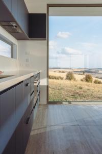 a kitchen with a large window with a view of a field at The Cloud at Sen Vineyard in White Hills