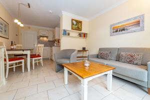 a living room with a couch and a table at Westerhörn 46 15 in Keitum
