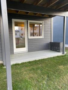 a porch with two windows on a house at Modern studio apartment in fantastic nature in Tromsø