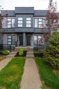 a gray house with a pathway in front of it at Cozy Gems of Kensington in Calgary