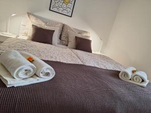 a bedroom with a bed with towels on it at Apartma Golob in Maribor