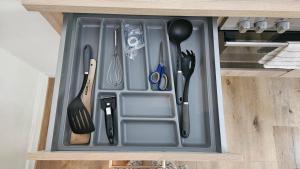 a drawer filled with utensils in a cabinet at Innenstadt Studio in Pforzheim