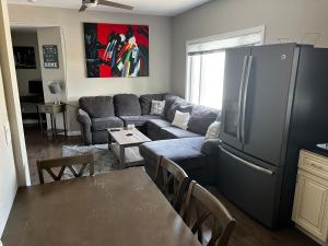 a living room with a couch and a refrigerator at Chelsea Condo’s in Chelsea