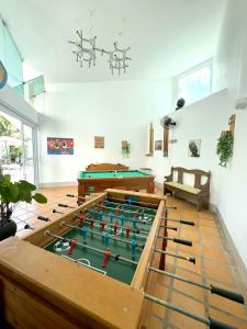 a living room with a pool table in the middle at Pousada Village Cozumel in Guarujá