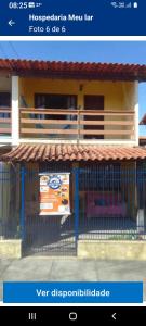 a picture of a house with a fence at Hospedaria Meu Lar in Rio das Ostras