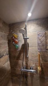 a shower in a bathroom with a shower at Cosy cottage in picturesque Hawkshead in Hawkshead