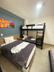a bedroom with two bunk beds and a painting at Hotel America 52 in Rionegro +65 photos