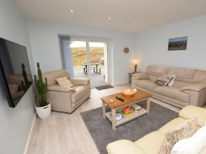 a living room with two couches and a table at 2 bed in Seamill 78991 in Ardrossan