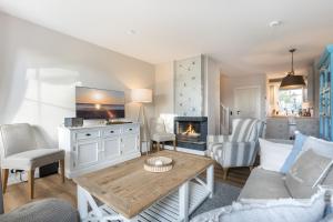 a living room with a couch and a fireplace at Ameland App 12 in Wenningstedt
