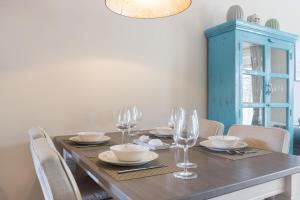 a dining room table with chairs and a blue cabinet at Ameland App 12 in Wenningstedt