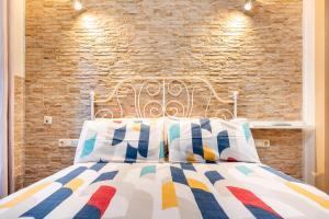 1 dormitorio con cama blanca y pared de ladrillo en Special Mcgomez next to the beach, en Málaga