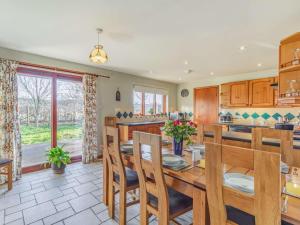 a kitchen and dining room with a table and chairs at 4 Bed in Warkworth 86132 in Warkworth