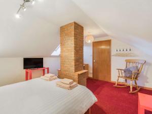 a bedroom with a bed with a brick chimney at 4 Bed in Warkworth 86132 in Warkworth