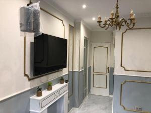 a living room with a flat screen tv on a wall at Po1-TPSA16-RDC- ROOM Paris 16 ème in Paris