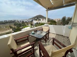 a patio with a table and chairs on a balcony at Actis studios 1 in Stelida