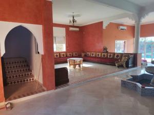 a large room with red walls and aasteryasteryasteryasteryasteryasteryasteryastery at Marrakech Luxury Villa Farm in Marrakesh