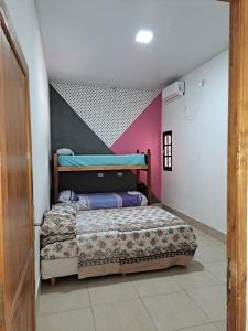a bedroom with a bed and a pink wall at Finca La Fortaleza zanjon in Santiago del Estero +8 photos