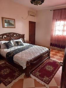 a bedroom with a bed in a room with a checkered floor at Marrakech Luxury Villa Farm in Marrakech