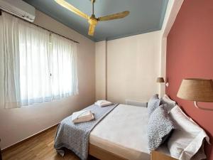 a bedroom with a bed and a ceiling fan at Apartment in the most artistic area of Koukaki in Athens