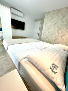 a bedroom with a large bed and a tv at Las Americas Bungamar apartment in Playa de las Americas +23 photos