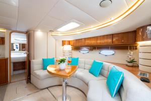 a living room with a couch and a table at Live the Unforgettable on a Princess V55 in Sorrento