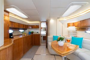 a dining room and kitchen with a table and chairs at Live the Unforgettable on a Princess V55 in Sorrento
