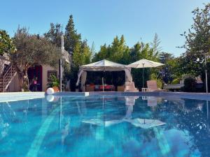 a large swimming pool with a gazebo at Art Villa Ines in Zadar