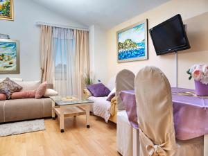 a living room with a couch and a tv at Art Villa Ines in Zadar +28 photos