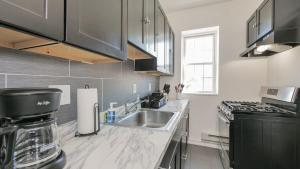 a kitchen with a sink and a counter top at Atlantic Suite by the Boardwalk 3A in Atlantic City