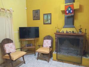 a living room with two chairs and a fireplace at Los Almendros in Verónica