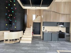 a kitchen with a staircase and a kitchenasteryasteryasteryasteryasteryasteryasteryastery at Cabin Zoobox 63 in Eastman +11 photos