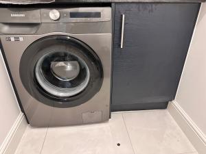 a washing machine sitting next to a dryer at Stylish Lux in Morley