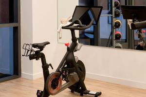 an exercise bike in front of a mirror at Sonder 17WEST in Miami Beach