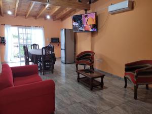a living room with a couch and a tv on the wall at Zafira in La Consulta