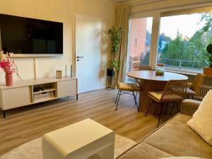 a living room with a tv and a table at Traumschmiede in Rellingen