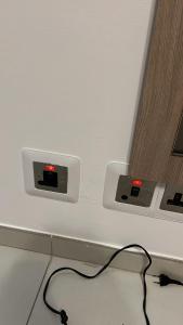 a desk with two electrical outlets on a wall at Modern 3BR Apartment in Swieqi in Is-Swieqi