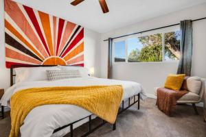 a bedroom with a bed and a large window at Cactus Cove Golf Pool Fitness! in Indio +34 photos