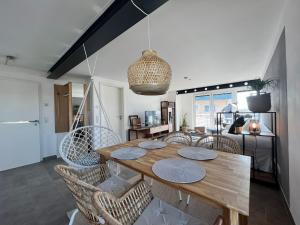 a dining room with a wooden table and chairs at Sonnenschein in Stetten