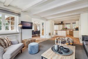 a living room with a couch and a table at Familier Hygge Hus in Braderup +17 photos