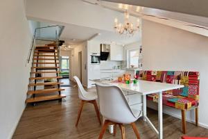 a kitchen and dining room with a table and chairs at Maisonette Alpenblick in Überlingen