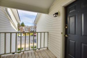 a door to a balcony with a view of a street at Greensboro Vacation Rental Condo Near Downtown in Greensboro