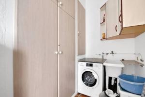 a small kitchen with a washing machine and a sink at Villa Anna in Jávea