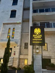a sign for a ryukyu suite in front of a building at RyLux Suits in Ramallah