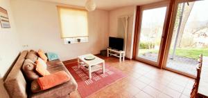 a living room with a couch and a tv at Bocasa Bodman in Bodman-Ludwigshafen +3 photos